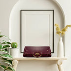 Women’s purple faux leather clutch purse featuring shimmering gold hardware