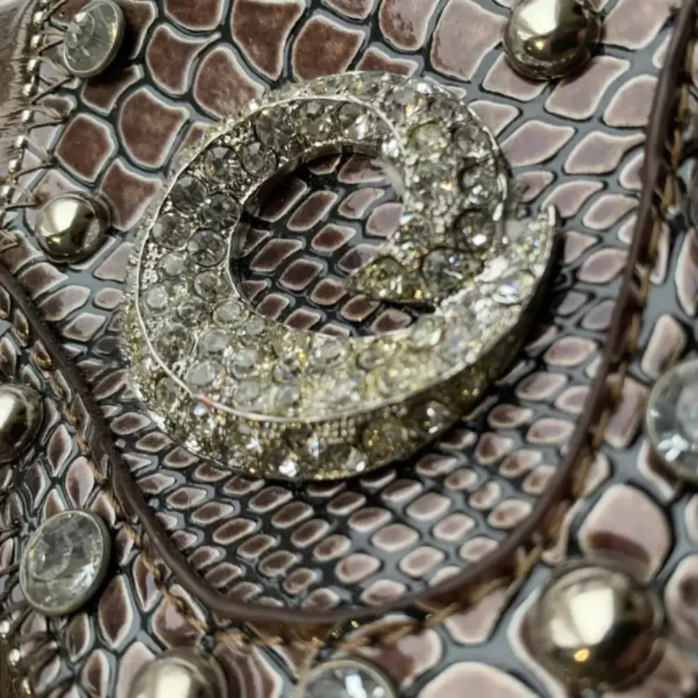 Elegant mini faux leather handbag featuring jeweled detailing and structured design