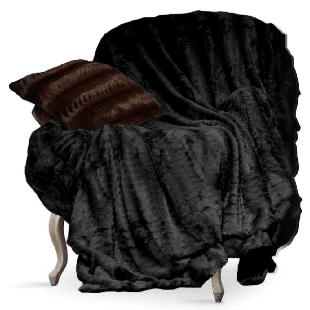 Luxury faux fur throw blanket styled in a chair for warmth and comfort Black