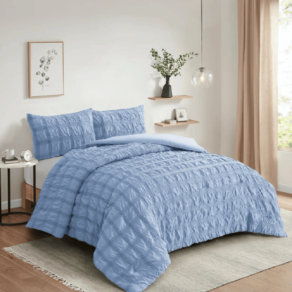 Seersucker microfiber comforter set styled on a bed for a fresh and comfortable bedroom look light blue