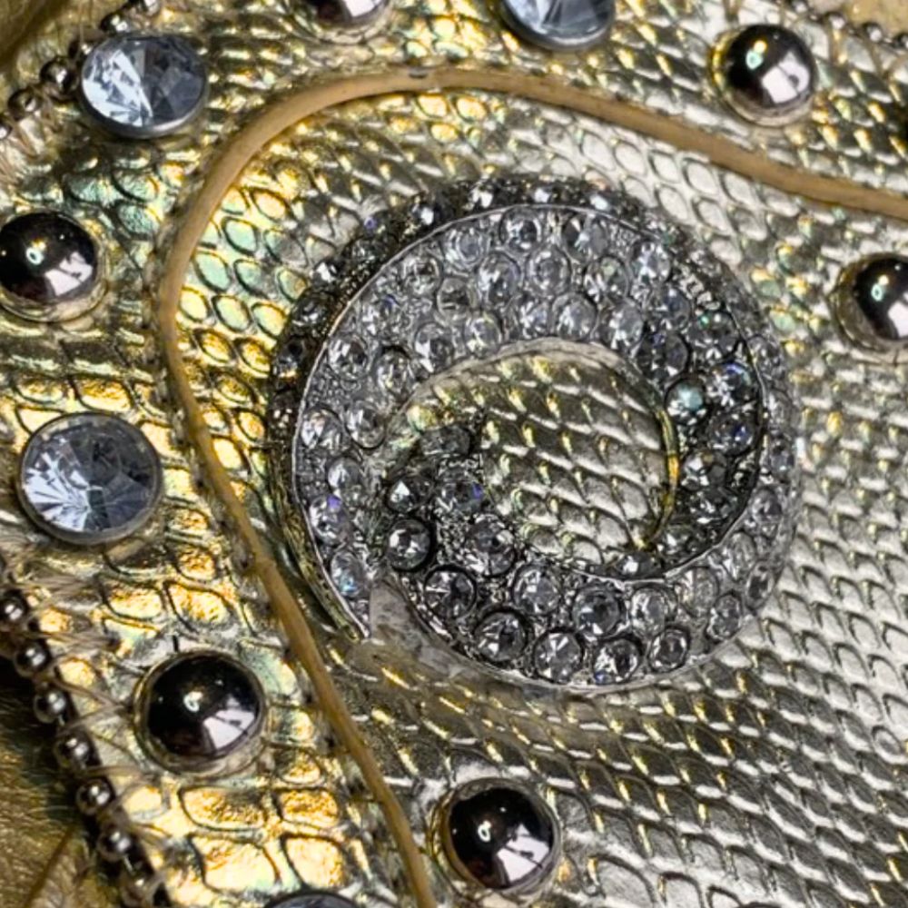 Fashionable small faux leather purse designed with decorative gem accents