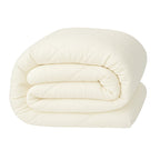 Hotel-style bedroom featuring a soft cotton-feel duvet with plush white