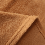 Hospitality-grade velour fleece blanket arranged for guest-ready bedding