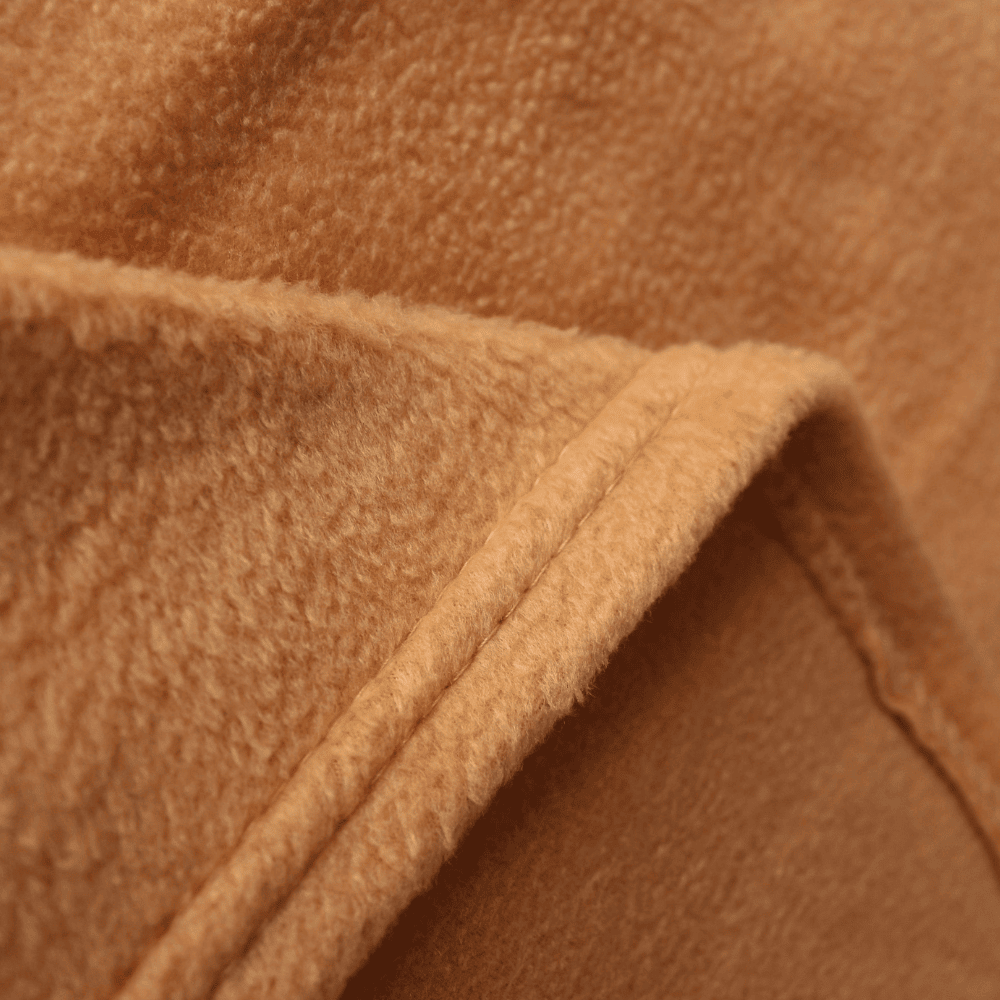 Hospitality-grade velour fleece blanket arranged for guest-ready bedding