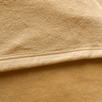 Close-up of velour fleece blanket texture in champagne color, showing plush softness and high-quality finish.