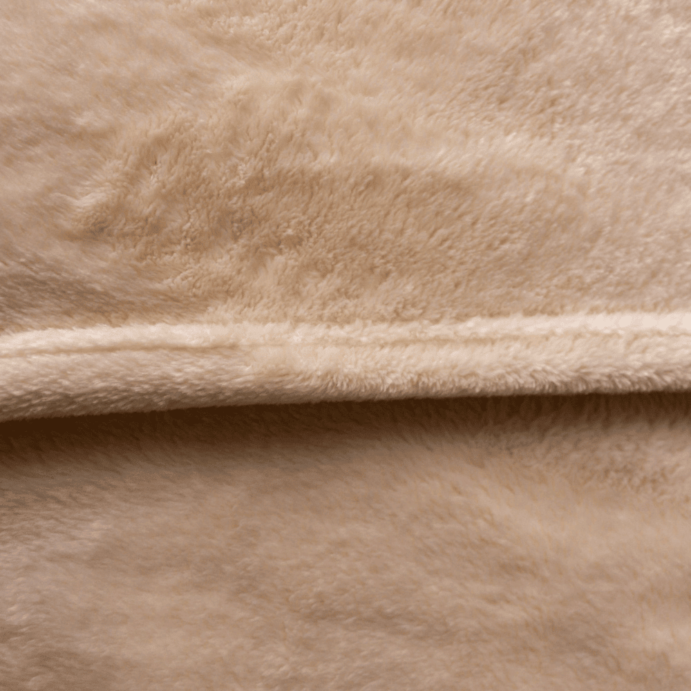 Close-up of velour fleece blanket texture in ivory color, showing plush softness and high-quality finish.